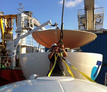 Acutec engineers assemble the Sea Tel C-Band VSAT alongside the ship in Sydney for Telstra